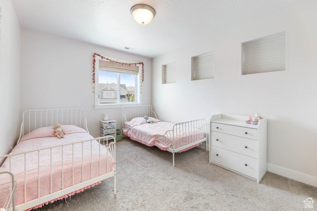 Bedroom with carpet floors and baseboards