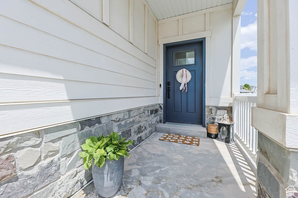 Doorway to property with stone siding