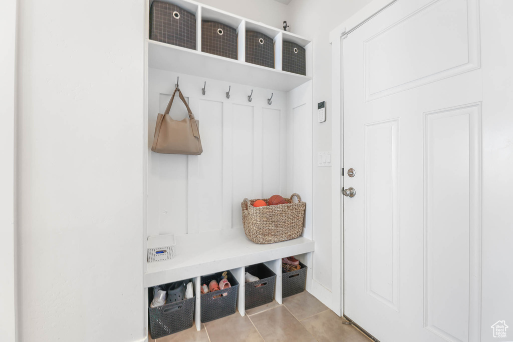 Mudroom with tile patterned flooring