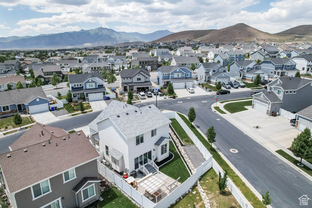 Aerial view of residential area featuring a mountainous background