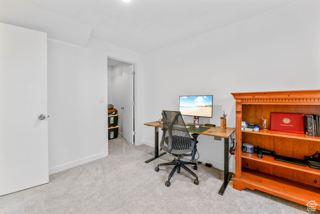 Carpeted office space featuring baseboards