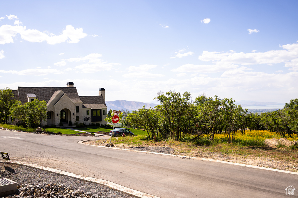 View of asphalt road featuring traffic signs