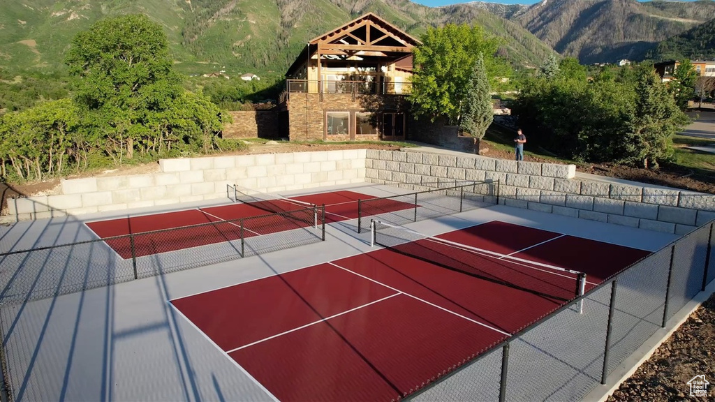 View of basketball court featuring a tennis court and a mountain view