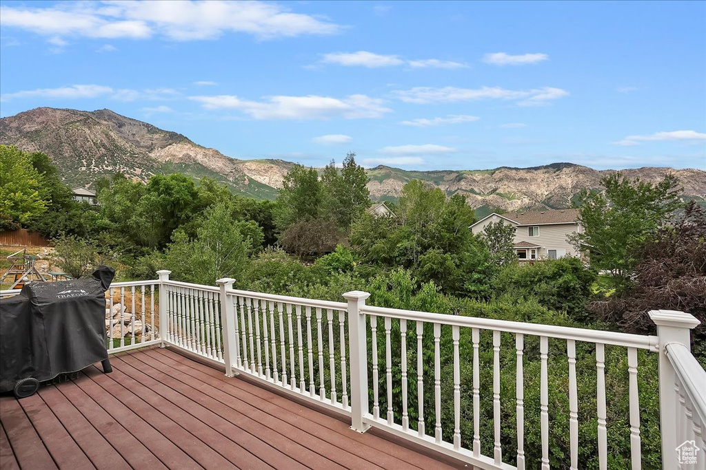 Deck with a mountain view and a grill