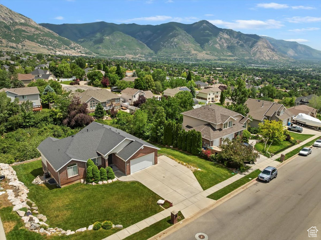 Aerial view of residential area featuring a mountainous background