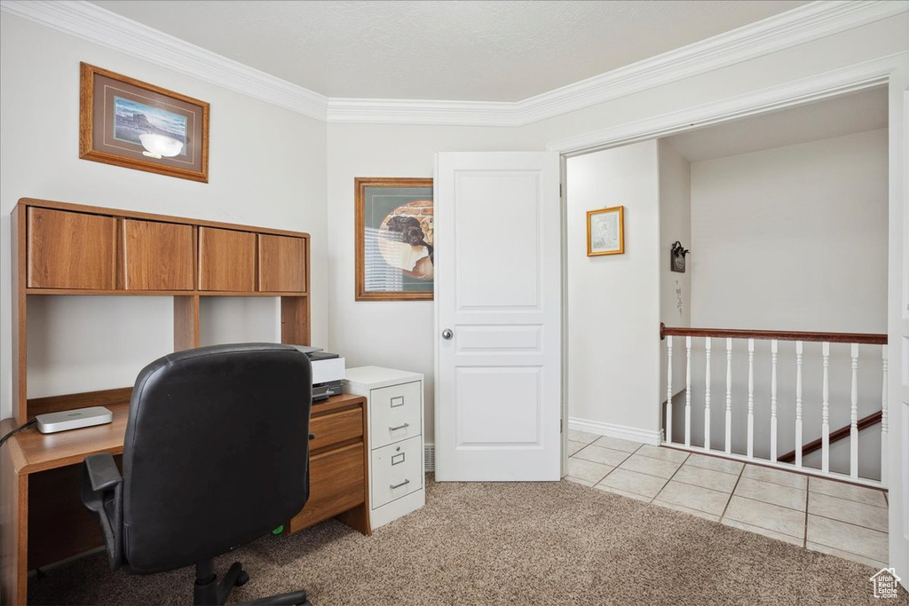 Office space featuring light carpet, ornamental molding, and light tile patterned floors