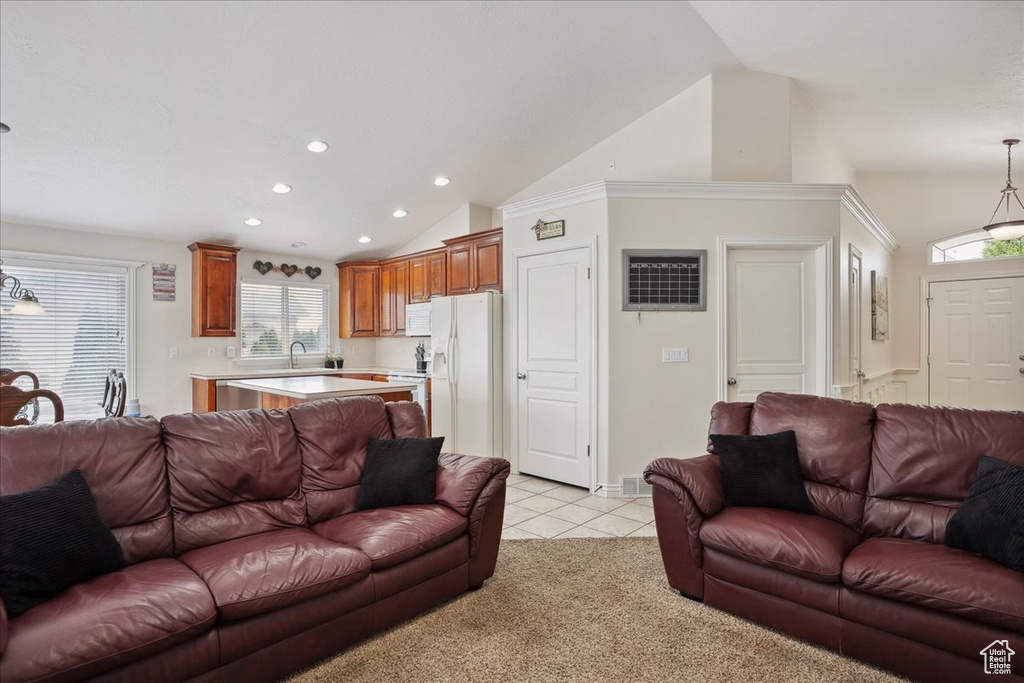 Living area featuring recessed lighting, vaulted ceiling, light tile patterned floors, and light carpet