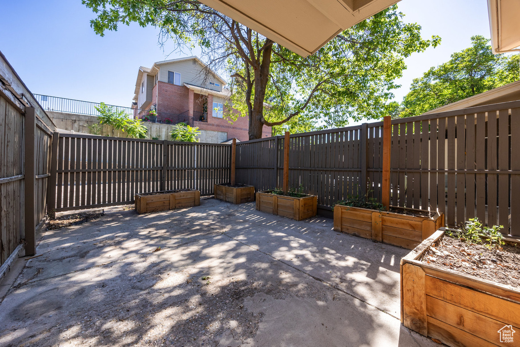 Fenced backyard featuring a patio