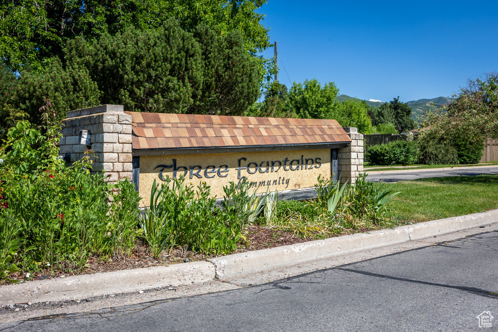 Community sign with a mountain view