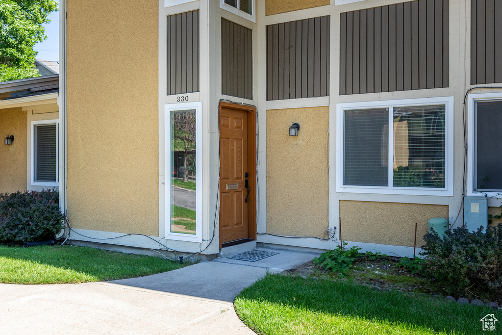 Property entrance featuring stucco siding