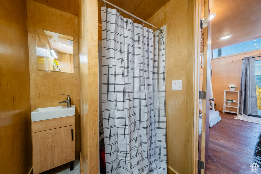 Bathroom featuring vanity, wood finished floors, and a shower with curtain