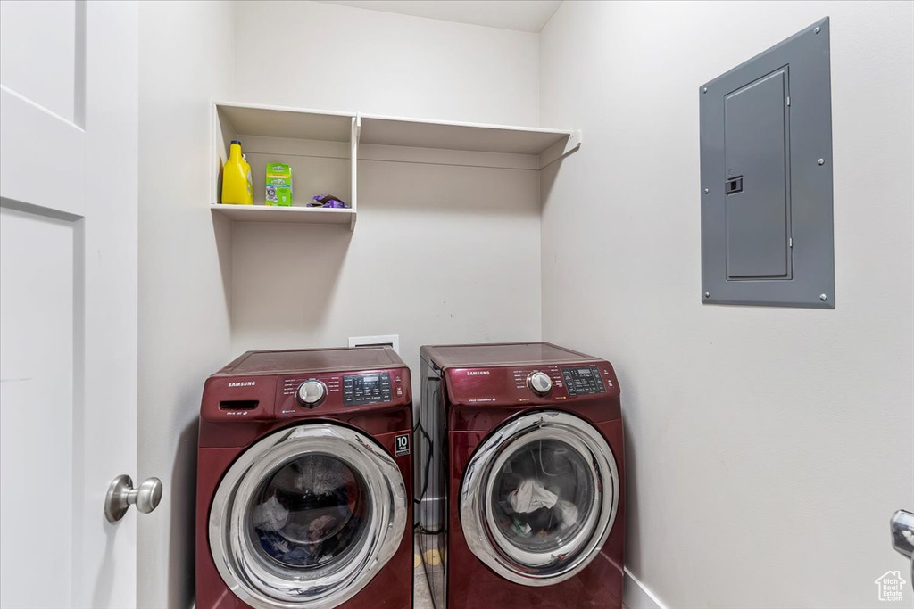 Laundry room with electric panel and independent washer and dryer
