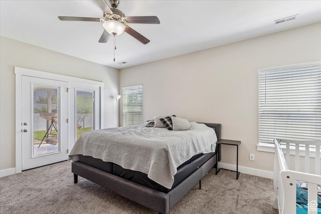 Bedroom featuring access to exterior, carpet flooring, and a ceiling fan