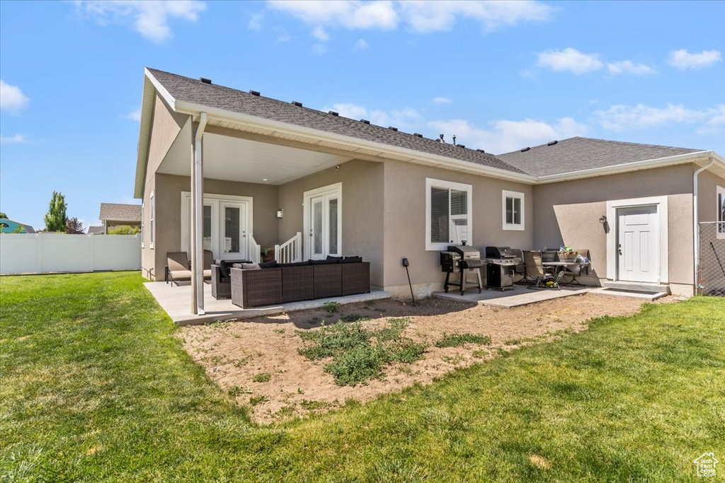 Rear view of house with an outdoor hangout area, a patio area, french doors, and stucco siding