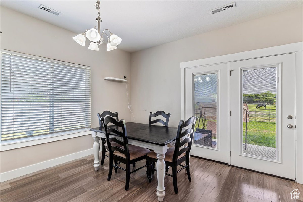 Dining area featuring a chandelier and wood finished floors