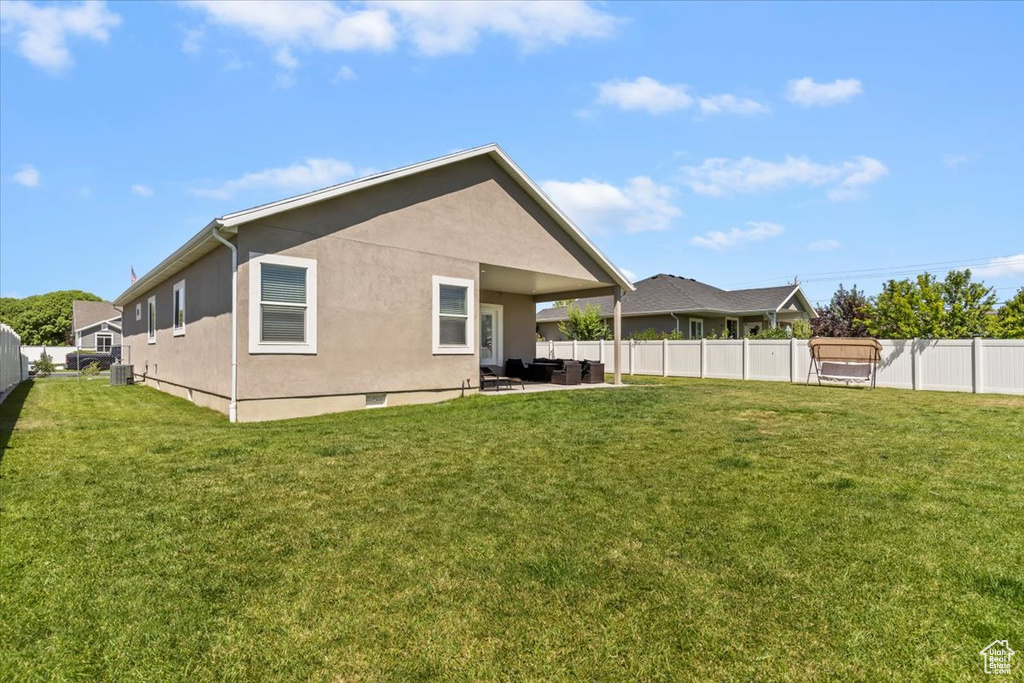 Rear view of house featuring a fenced backyard, stucco siding, a patio, and crawl space