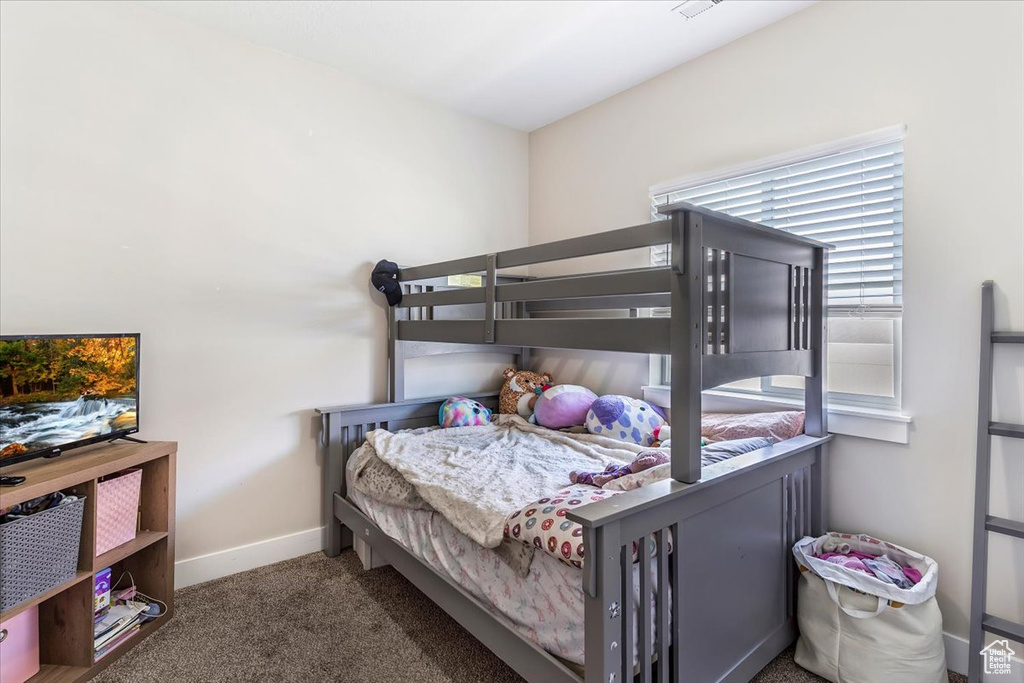 Carpeted bedroom featuring baseboards