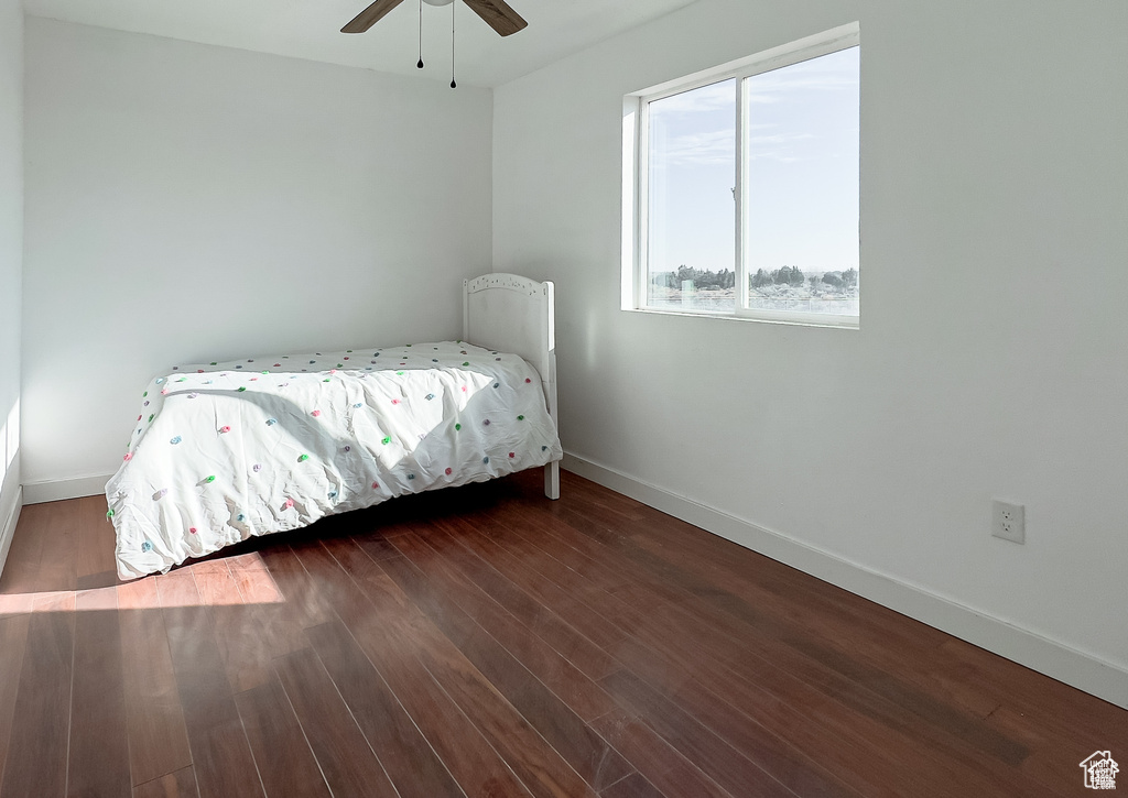 Bedroom with wood finished floors and ceiling fan