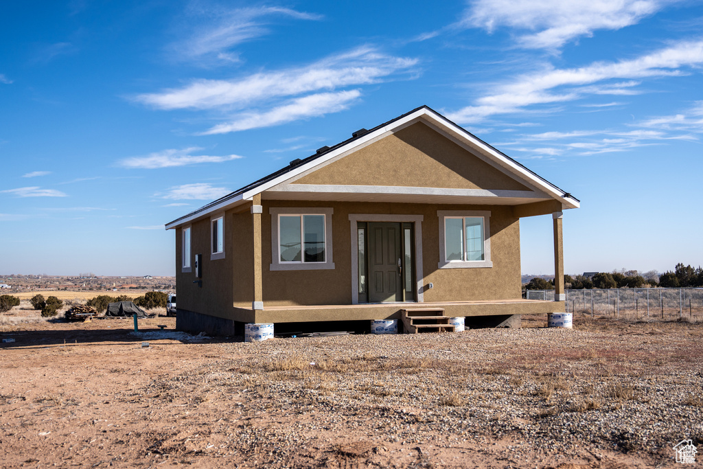 View of front of property featuring stucco siding and a porch