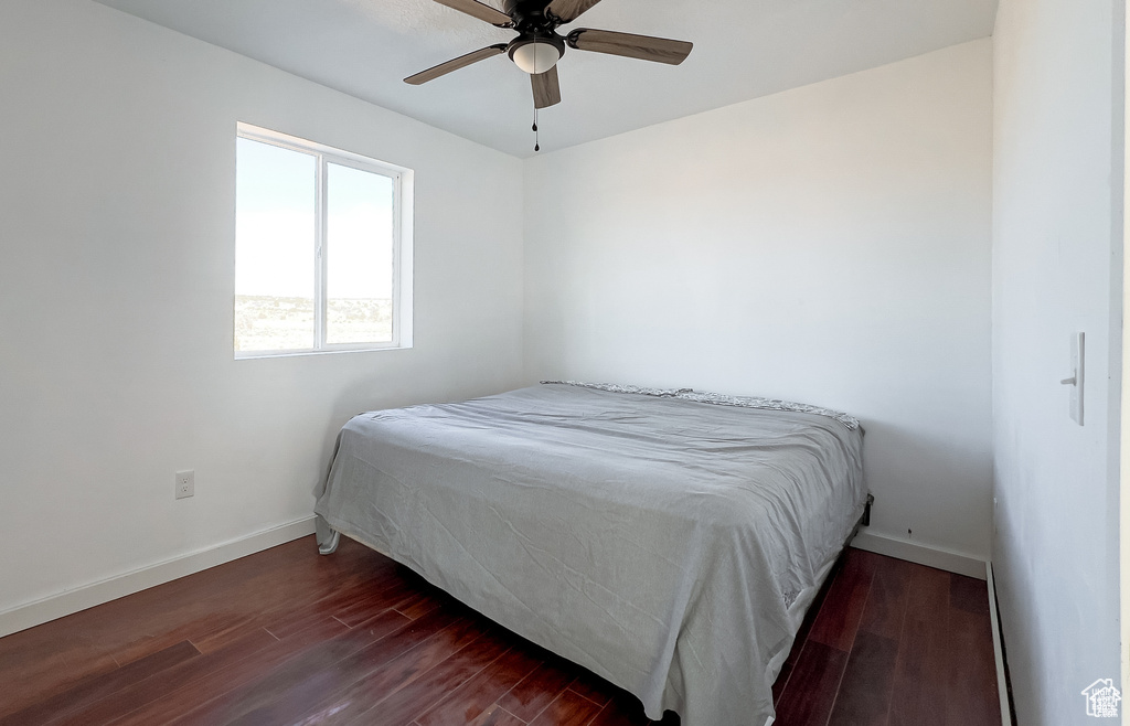 Bedroom with dark wood-style flooring and ceiling fan