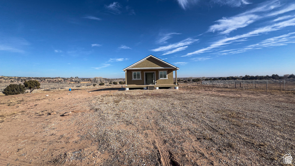Back of property featuring a view of rural / pastoral area