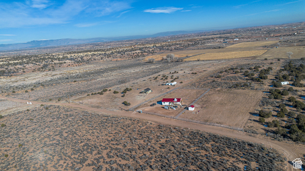 Aerial view of sparsely populated area with mountains and a desert landscape