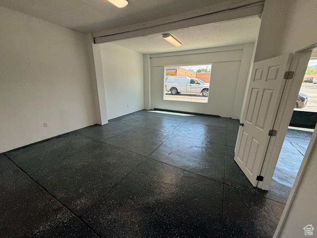 Unfurnished room featuring a textured ceiling