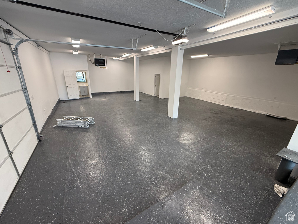 Garage featuring a heating unit and a garage door opener