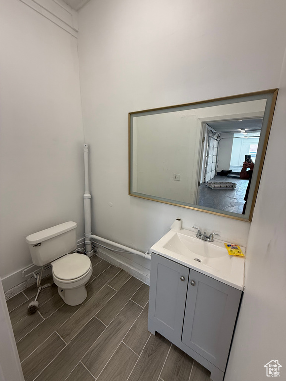 Half bathroom featuring vanity and wood tiled floors