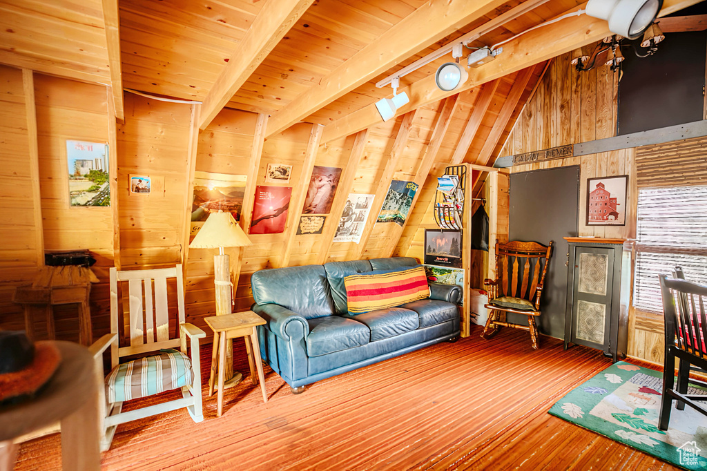 Living area featuring wooden walls, wood finished floors, and wooden ceiling