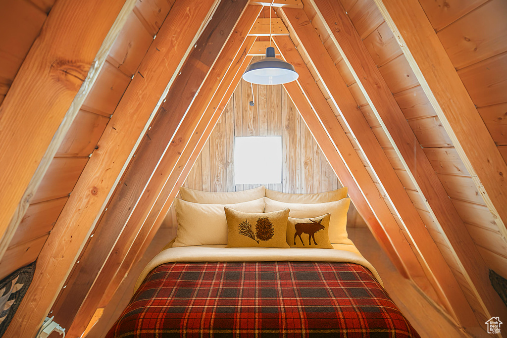 Sitting room featuring lofted ceiling and wooden walls