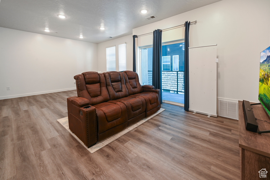 Living room with wood finished floors and recessed lighting