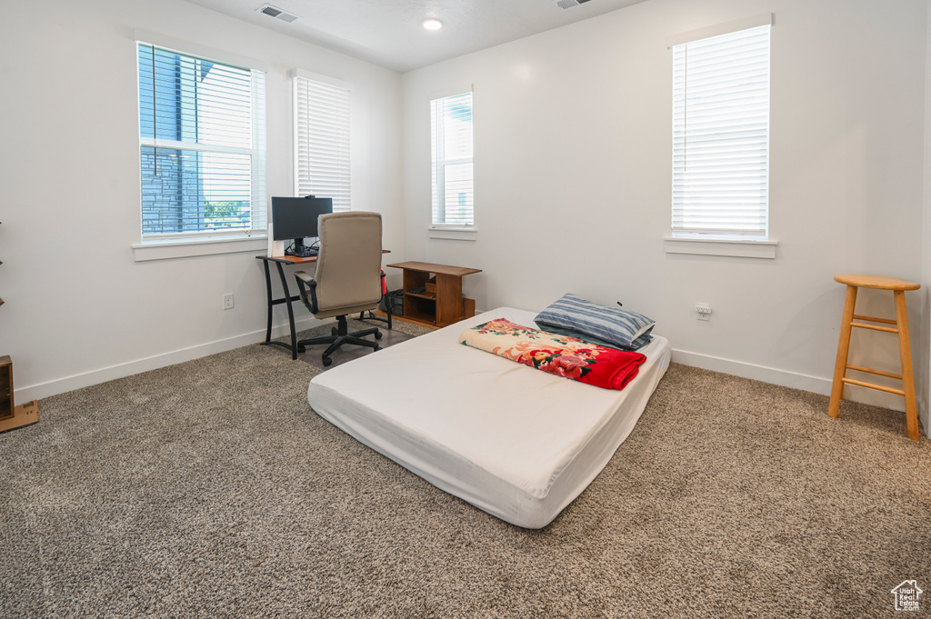 Carpeted bedroom featuring baseboards
