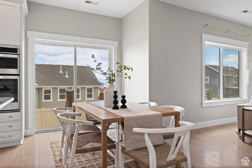 Dining area with light wood-style floors