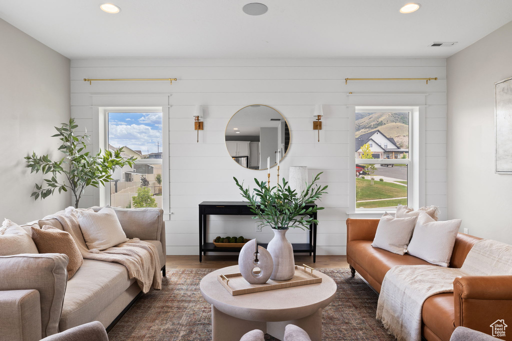 Living room featuring plenty of natural light, recessed lighting, and dark wood-style floors