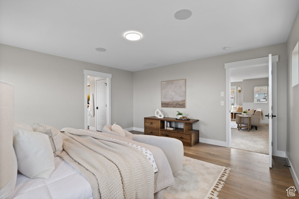 Bedroom with wood finished floors and baseboards
