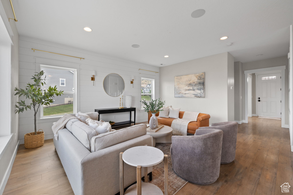 Living room with wood-type flooring and recessed lighting