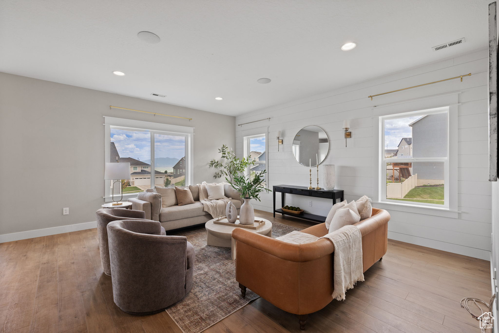 Living room with hardwood / wood-style floors and recessed lighting