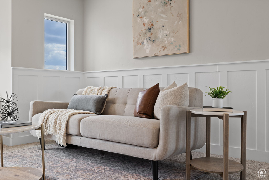 Living area with a decorative wall and a wainscoted wall