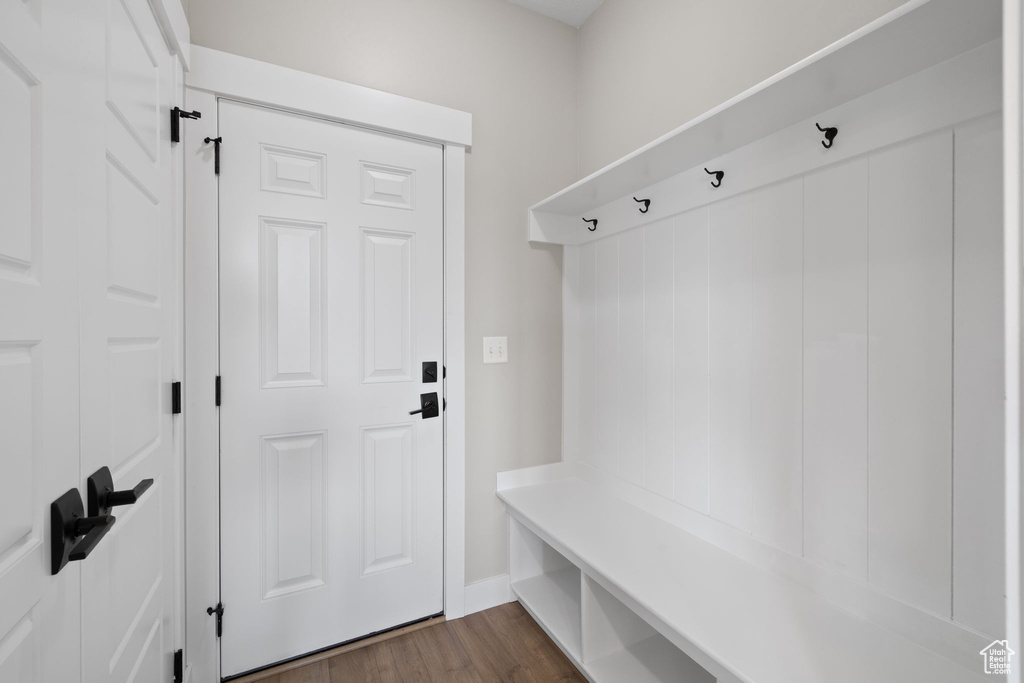 Mudroom with dark wood-style floors and baseboards