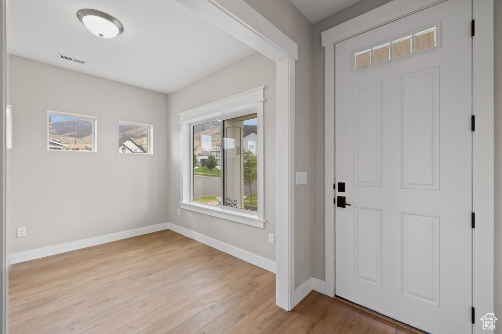Foyer featuring baseboards and wood finished floors