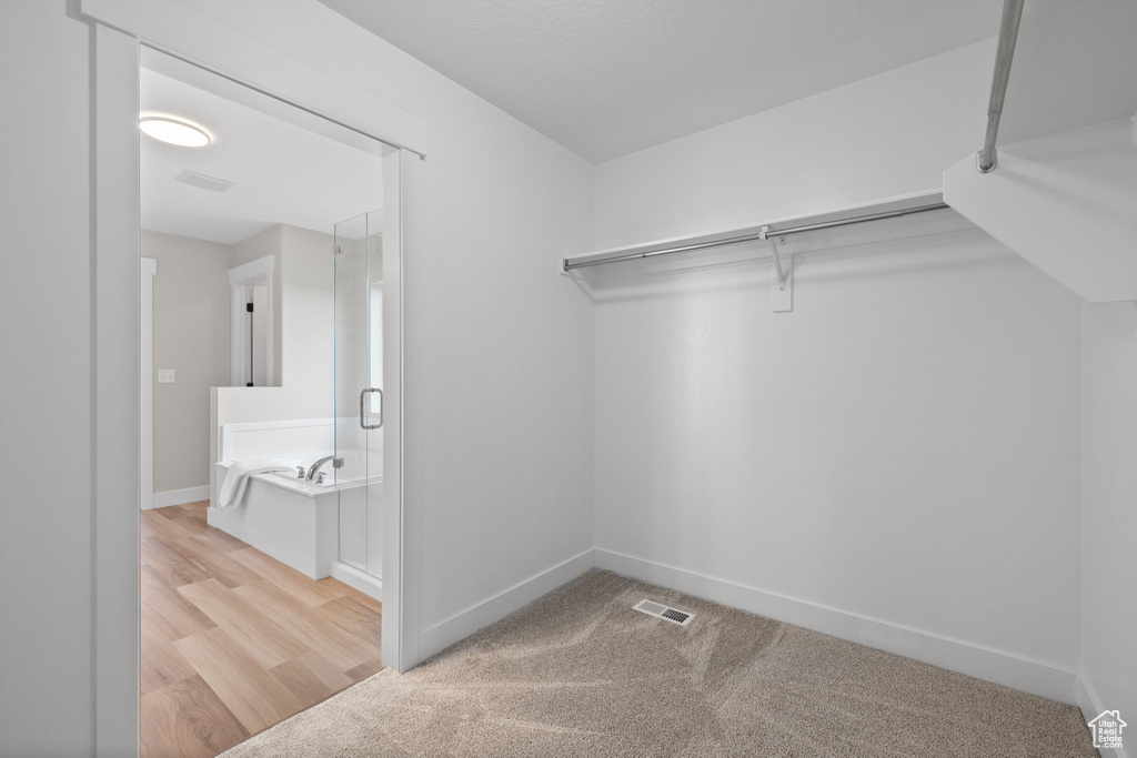 Spacious closet featuring wood finished floors