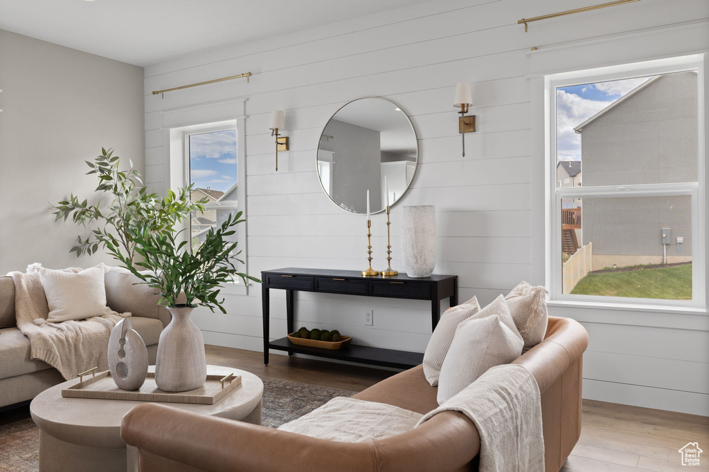 Living area with wood finished floors and wooden walls