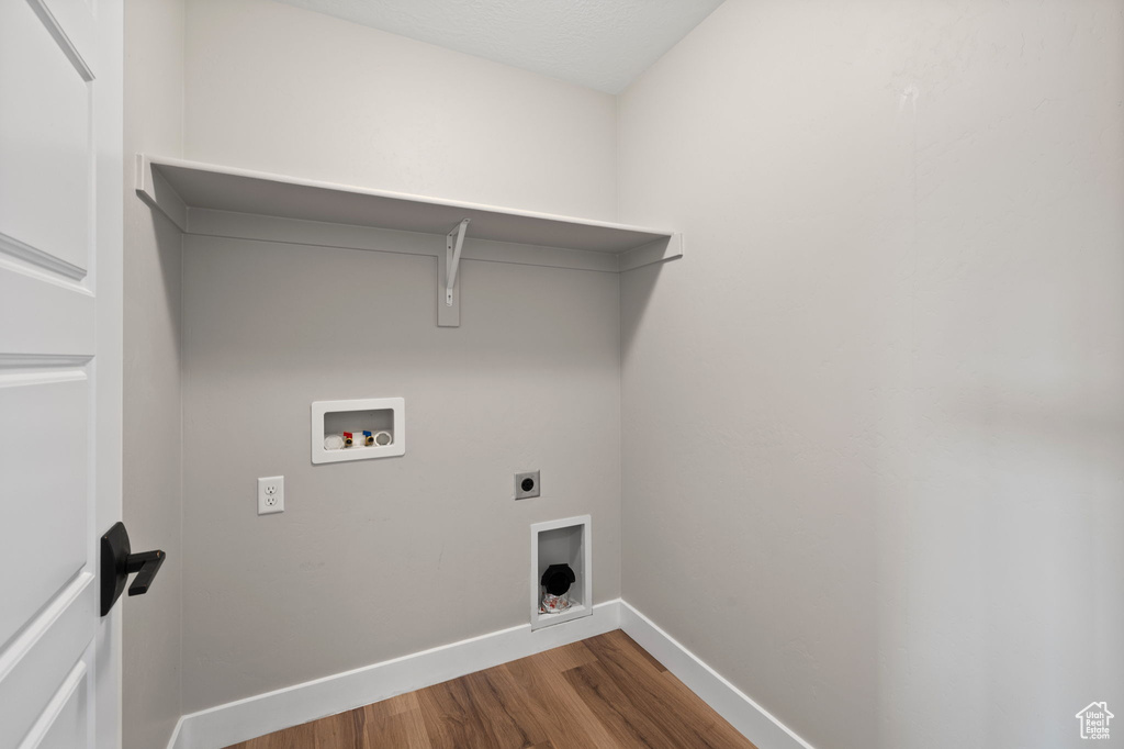 Washroom featuring wood finished floors, hookup for an electric dryer, and washer hookup