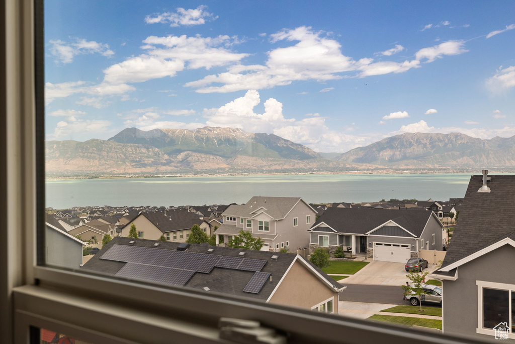 View of mountain background with a nearby body of water and nearby suburban area