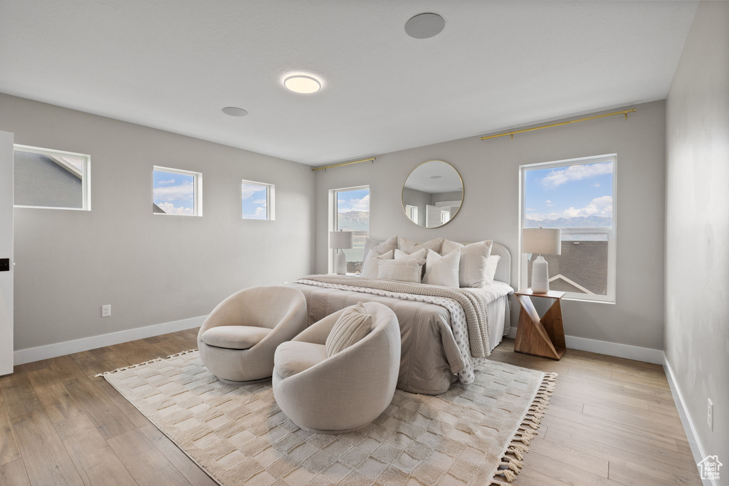 Bedroom with wood finished floors and baseboards