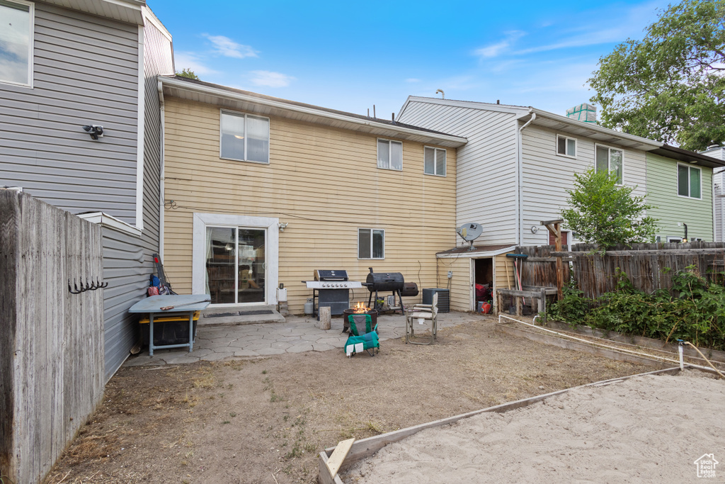 Rear view of property featuring a patio and a fenced backyard