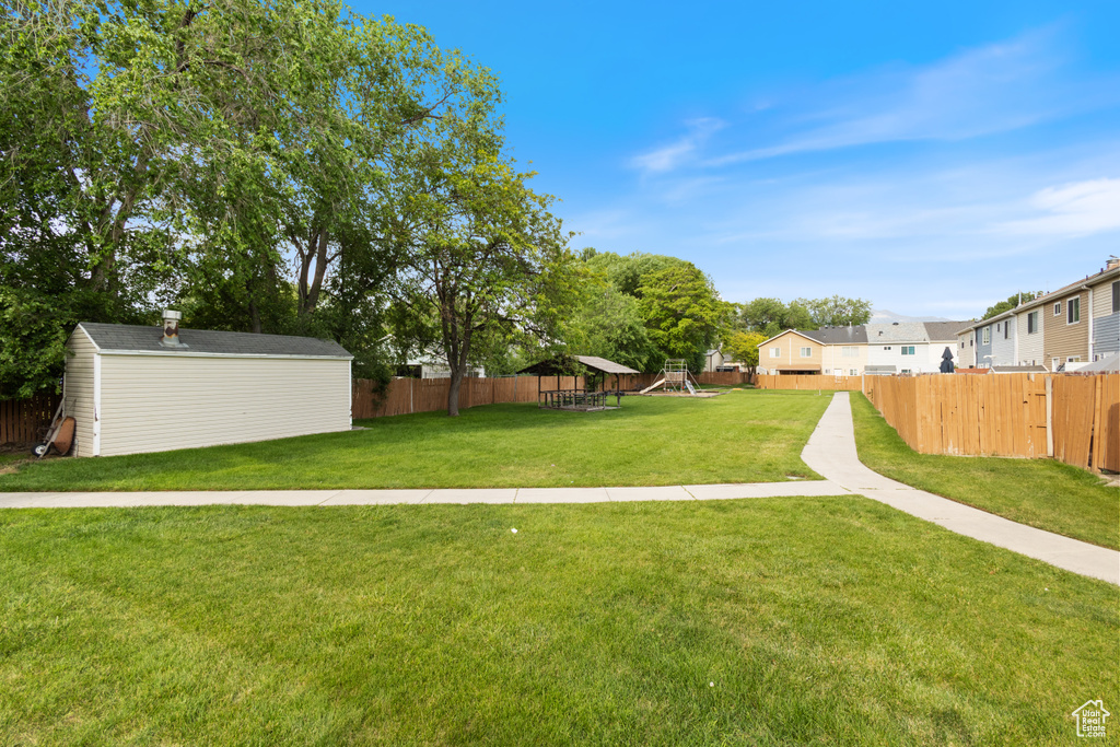 View of yard with a shed and a playground
