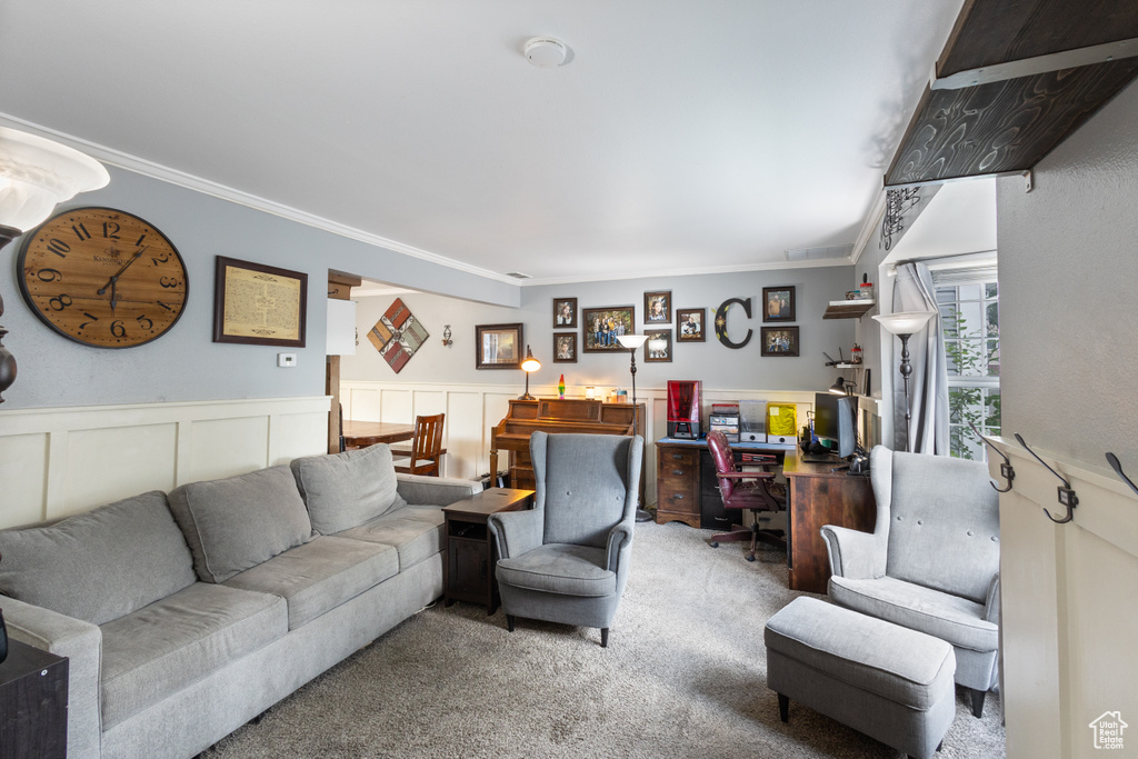 Living room featuring carpet, ornamental molding, an office area, and a wainscoted wall