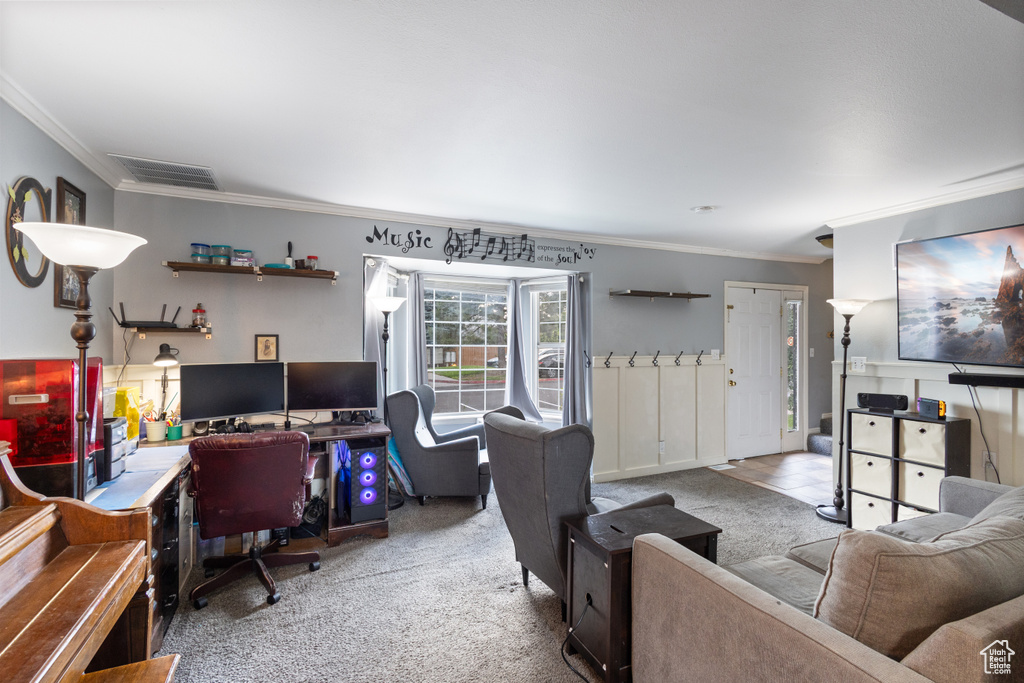 Living area featuring a desk, crown molding, and carpet floors